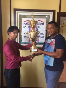 Internal Auditor at NAlico-NAfico Insurance Company, Vickash Persaud (left) hands over the first place trophy to NEE’s, Winston Fraser.