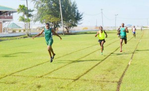 Jason Yaw (left) comes home comfortably ahead of Cleveland Thomas and Patrick King yesterday in the AAG Development Meet at the Guyana Defence Force Base Camp Ayangana Ground.