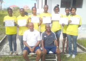 The newly trained Referees display their certificates in the presence of one of the facilitators, Roy McArthur (seated left) at right is EDFA Executive, Joseph Wilson. 