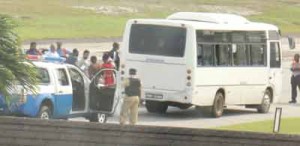 The deportees were placed in a waiting bus under police guard at CJIA