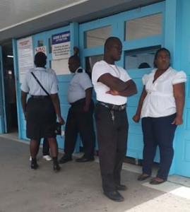 Prison warders waiting in front of the Hospital’s Emergency Unit yesterday while their colleague was being treated. 