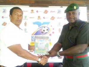 Ann’s Grove FC President Major Raul Jerrick collects the tournament’s rules and regulations handbook from organiser Kashif Muhammad. 