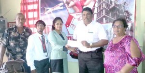 Zaleena Ramkishun, Supervisor attached to the New Amsterdam Branch of Hand in Hand Insurance Company hands over sponsorship cheque to BCB President Anil Beharry in the presence of Surendra Shivrattan (2nd left), an employee of the sponsor. Looking on are Angela Haniff (right) and Carl Moore of the BCB. 