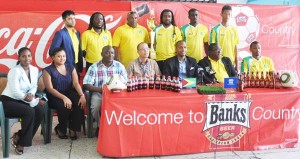 GFF NC Chairman Clinton Urling (seated 3rd right), Head Coach Jamaal Shabazz (2nd right), Captain Chris Nurse (right) along with Banks DIH Brand Executive Brian Choo- Hen (centre), other officials of the entities and some members of the Golden Jaguars pictured at the launching ceremony. 