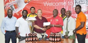 Banks DIH Communications Manager Troy Peters (4th right) hands over the cheque to GRFU President Peter Green in the presence of officials yesterday. 