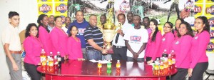 General Manager Robert Selman (right centre) hands over the winning trophy to Petra Organisation Co-Director Troy Mendonca in the presence of staffers and players yesterday.