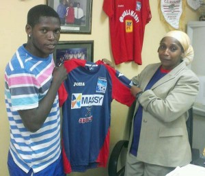 Domini Garnett is presented with his shirt by Caledonia AIA General Manager Ricarda Nelson.   