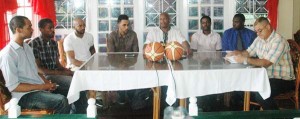 GABF President, Nigel Hinds (centre) addresses the media yesterday in the presence of National Coach, Darcel Harris (on his left), some of the Bermudian players on his right and other officials from Guyana at WindJammer Hotel.