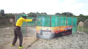 Guyana’s leading handgun shooter Ryan McKinnon on a stage constructed of the mesh walls in Suriname.