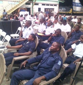 The group of pilots and mechanics await their certificates.