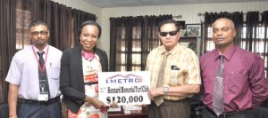 Metro’s Avia Maria Lindie (second left) presents Justice Cecil Kennard with the sponsorship cheque, while Metro’s Warehouse Manager Christopher Persaud (extreme left) and Manager of the Document Centre Barnard Ramsaroop look on.