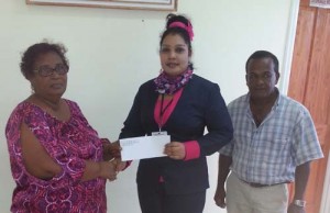 Miss Bibi Faneza Ally hands over sponsorship cheque to Angel Haniff, Secretary of the Berbice Cricket Board in the presence of board executive Rabindranauth Saywack.