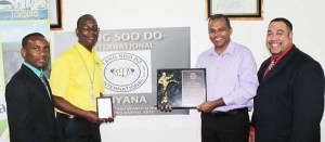 From left; Roland Eudoxie Fly Jamaica Senior Marketing Officer Wesley Tucker, Minister of Sport Dr. Frank Anthony and Master Jose Torres. 