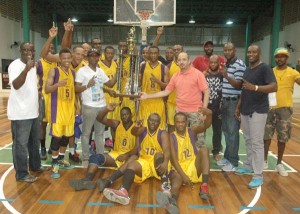 Mackeson Brand Manager, Jamaal Douglas (third, left, front row) hands over the Championship Trophy to Pacesetters’ guard Travis Burnett and his team as GABF Vice-President (Operations), Michael Singh also upholds the hardware.