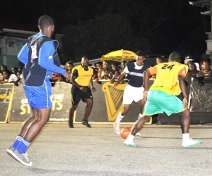Plaisance ‘A’ leading marksman Warren Gilkes (green bib) battles for possession of the ball with an opposing player during their encounter against Paradise on Friday evening.