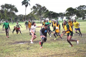 Members of the national rugby squad seen in a practice game against a Rest Side last Saturday on a waterlogged National Park Playfield. 