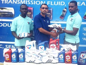 Sankar’s Dwayne Rodrigues (second from left) makes the presentation to Marvin Goodman yesterday. 