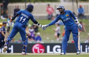 Sri Lankan batsman Tillakaratne Dilshan (R) and his team mate Kumar Sangakkara congratulate each other on their 150 run partnership during their Cricket World Cup match against Scotland in Hobart March 11, 2015. REUTERS-David Gray