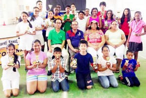 Winners of the Trophy Stall Badminton tournament display their prizes.