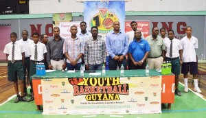 GABF President, Nigel Hinds (front row, third right) and YBG Director, Chris Bowman (on his right) along with sponsors and schools yesterday usher in the 10th Schools’ Basketball Festival at the Cliff Anderson Sports Hall.