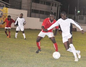 Action in the opening game between Rhythm Squad (in red) and New Amsterdam United, which the former won on penalties.