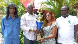 Aubrey ‘Shanghai’ Major (2nd left) accepts the trophy from Farina Razac in the presence of her brother, Fazeel (left) and Frank Jones, respectively.