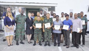 GDF personnel with certificates poses with facilitators and other senior officials.