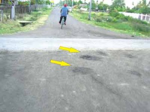  This photo shows holes developing in the road which was recently done by a contractor.