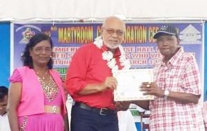 President Ramotar honours the oldest Estate worker at Rose Hall, Mr. Bissoon.