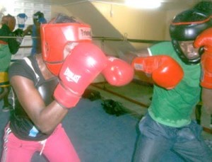 Female boxer, Taseka Howard (l) mixes it up with Delon Charles during sparring sessions.
