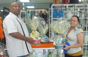 Marketing Manager of De Sinco, Ms. Sarah Savoury hands over hampers Hilbert Foster.