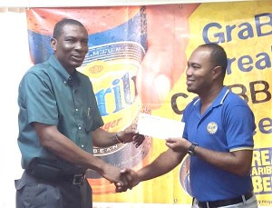 Ansa McAl’s Brand Coordinator, Nigel Worrell (right) hands over the sponsorship to President of the GCA, Roger Harper at Ansa McAl’s Headquarters, Beterverwagting.