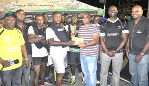 Berbice Branch Manager Jost Terrazao (3rd right) hands over the first prize money to Captain of the victorious Manchester unit in the presence of Guinness Brand Manager Lee Baptiste (2nd right), Outdoor Events Manager Gavin Jodhan, Communications Manager Troy Peters (left) and team members.