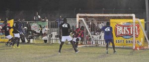 Goallllll…Sparta Boss Sheldon Shepherd (partly hidden on the left flank) beats Charlestown goalkeeper to his left in their clash on Tuesday night, at the GFC ground.