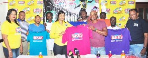 Busta Regional representative Christine Kellawan hands over one of the jerseys to one of the teams’ Captain in the presence of players and Guyana Beverages Inc and Petra Organisation officials.