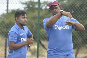 Coach Phill Simmons (right) makes a point to Devendra Bishoo during practice. (WICB)