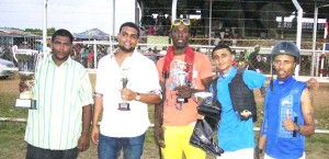 Connections of the Jumbo Jet stable after sweeping all of the individual prizes – (2nd left) Coordinator Nazrudeen Jumbo Jet Mohammed Jr, along with Trainer Carlton ‘Black Mouth’ Pluck, Jockeys P. Badrie and Ronald Ally show off their silverware.