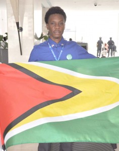 Ja’asriel Bishop holding the Guyana flag after the forum in Panama City.