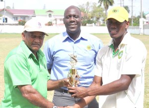 Keno Paul collects his Man-of-the-Match award from former West Indies Test batsman Alvin Kallicharran as Match Referee (center) looks on. 