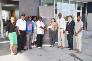 Marriott Director of Marketing Denisse Olivo (right) presents the sponsorship cheque to organsier Leslie Black in the presence of other representatives of the sponsors and organsiers. 