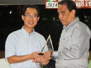 Consular Officer at the Chinese Embassy in Guyana, Yuyin Liu (left) hands over the Award to Mike Baptist Saturday night.