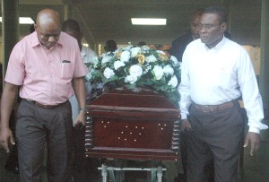 Pall Bearers carry the body the late William Byron Orlando Michael out of the Central Assembly of God Church yesterday following a Funeral Service.