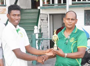 Keemo Paul accepts his prize from selector Nazium Drepaul.