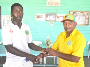Man of the match Sherfene Rutherford collects his trophy from former West Indies batsman Alvin Kallicharran. 