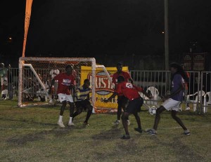 Action in the clash between West Front Road (purple jerseys) and North East La Penitence on Friday.