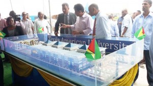 From right: Minister of Agriculture, Dr Leslie Ramsammy, Dr Madan Rambarran, and others examine an artist impression of the new campus.