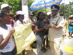 Flashback: Police Commissioner Leroy Brumell meets Agricola residents who were protesting the killing of 17-year-old Shaquille Grant. 