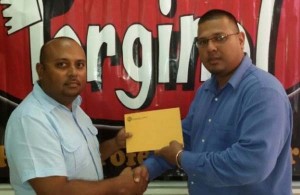 Torginal Manager Avalon Jagnandan (right) hands over sponsorship cheque to LGC President David Mohamad.