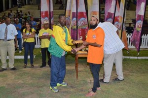 Assad Fudadin of the Rose Hall Town Youth and Sports Club presents a contribution to the late Calvin Roberts (left), Sports Reporter of the Guyana Chronicle.