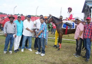 Connections of the champion Jumbo Jet stable receives the trophy for Keep On Swinging victory.